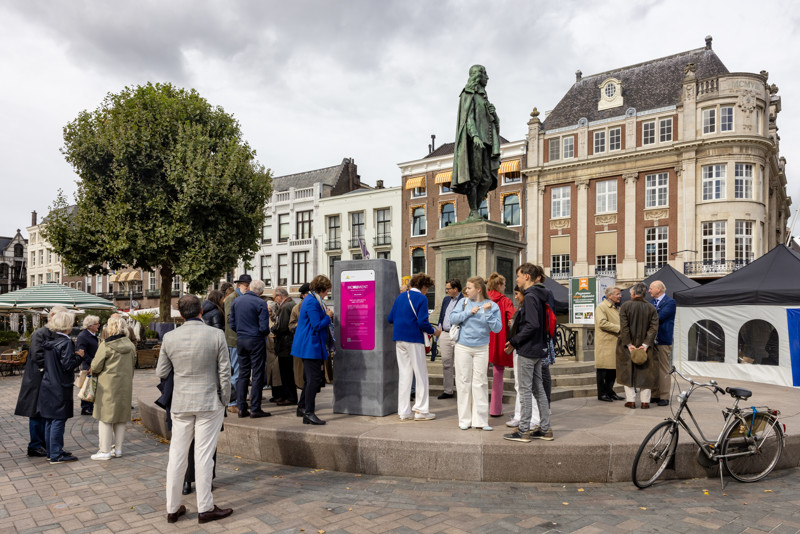 Bezoekers en voorbijgangers bekijken het spiegelmeubel en het monument (Foto Gemeente Den Haag)